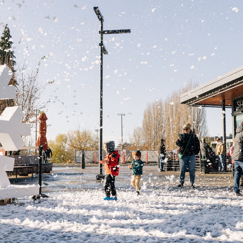 Crowds enjoying WinterFest at Kirkland Urban, with seasonal lights and activities in the plaza.